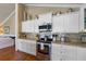 Gourmet kitchen with granite counters, stainless appliances, and white cabinetry at 612 Fern St, Anna Maria, FL 34216
