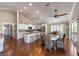 Spacious kitchen with ceiling fans, vaulted ceiling, hardwood floors, seated island and stainless appliances at 612 Fern St, Anna Maria, FL 34216