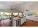 Open kitchen floor plan with granite counters, seated island, ceiling fans and stainless appliances at 612 Fern St, Anna Maria, FL 34216