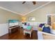 Comfortable and coastal decorated living room with hardwood floors, ceiling fans, and ample natural light at 612 Fern St, Anna Maria, FL 34216
