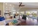 Bright living room with ceiling fans, vaulted ceiling, hardwood floors and sliding glass doors to the deck at 612 Fern St, Anna Maria, FL 34216