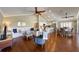Bright living room with ceiling fans, vaulted ceiling, hardwood floors with kitchen in the background at 612 Fern St, Anna Maria, FL 34216