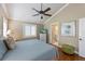 Comfortable bedroom with coastal decor, hardwood floors and ensuite bathroom at 612 Fern St, Anna Maria, FL 34216