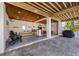 Entertaining outdoor space under a covered patio with seating, tables, and a grill at 612 Fern St, Anna Maria, FL 34216