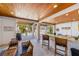 Open outdoor living space with a bar, seating area, and grill, perfect for entertaining by the pool at 612 Fern St, Anna Maria, FL 34216