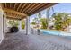 Inviting outdoor area featuring a pristine pool surrounded by lush landscaping and comfortable seating on a brick patio at 612 Fern St, Anna Maria, FL 34216