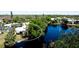 Scenic aerial view of the property showcasing its proximity to a beautiful lake with a fountain and lush landscaping at 631 Woodlawn Dr, Bradenton, FL 34210