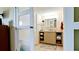 This bathroom features a vanity with storage, a mirror, and neutral tiling at 631 Woodlawn Dr, Bradenton, FL 34210