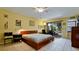 This cozy bedroom has tile flooring and access to the outdoor patio at 631 Woodlawn Dr, Bradenton, FL 34210