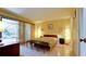 A bright, modern bedroom with tiled floors, bench, and sliding glass door to patio at 631 Woodlawn Dr, Bradenton, FL 34210