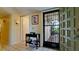 Welcoming foyer with tiled floors, elegant console table, decorative lighting, and front door with security features at 631 Woodlawn Dr, Bradenton, FL 34210