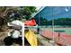 Various kayaks are stored on the rack next to the tennis court, offering watersport opportunities for active residents at 631 Woodlawn Dr, Bradenton, FL 34210