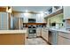 Updated kitchen with stainless steel appliances and light wood cabinets at 631 Woodlawn Dr, Bradenton, FL 34210
