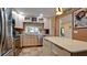 Updated kitchen featuring stainless steel appliances and a center island with countertop at 631 Woodlawn Dr, Bradenton, FL 34210