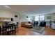 Open-concept living room featuring hardwood floors, modern furniture, and a large window at 631 Woodlawn Dr, Bradenton, FL 34210