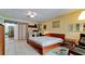 Spacious main bedroom features tile floors, ceiling fan, and natural light at 631 Woodlawn Dr, Bradenton, FL 34210