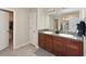 Bathroom with double vanity, granite countertops, and tile flooring. Walk in closet is also visible at 6723 Trent Creek Dr, Sun City Center, FL 33573