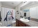 Charming bathroom with a fun shark-themed shower curtain and vanity at 6723 Trent Creek Dr, Sun City Center, FL 33573