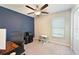 The bedroom has a ceiling fan, desk, and blue accent wall at 6723 Trent Creek Dr, Sun City Center, FL 33573