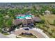 Stunning aerial view of the community pool and clubhouse with ample seating and lush landscaping at 6723 Trent Creek Dr, Sun City Center, FL 33573