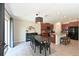 Open-concept dining area with a stylish light fixture and views into the well-equipped kitchen at 6723 Trent Creek Dr, Sun City Center, FL 33573