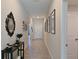 Long hallway with tile flooring, neutral paint and modern decorative finishes at 6723 Trent Creek Dr, Sun City Center, FL 33573