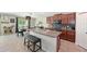 Modern kitchen featuring granite countertops, sleek cabinets, and an open layout to the dining space at 6723 Trent Creek Dr, Sun City Center, FL 33573