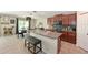 Well-equipped kitchen with an island, stainless steel appliances, and views into the dining area at 6723 Trent Creek Dr, Sun City Center, FL 33573
