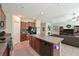 Open-concept kitchen features a granite island, tile flooring, and seamless flow into the adjacent living space at 6723 Trent Creek Dr, Sun City Center, FL 33573