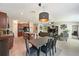 Open-concept living space with modern light fixture, connecting the kitchen, dining, and living areas seamlessly at 6723 Trent Creek Dr, Sun City Center, FL 33573