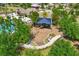 Aerial view of community playground with swings and slides near pool and seating areas within the community at 6723 Trent Creek Dr, Sun City Center, FL 33573