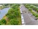 Aerial view of townhome community and pond, highlighting the community's layout and proximity to nature at 7180 83Rd E Dr # 6-5, Bradenton, FL 34201