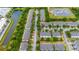 Aerial view of community with pond and power station nearby, showing townhome layout and streetscape at 7180 83Rd E Dr # 6-5, Bradenton, FL 34201