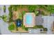 Overhead view of the community pool, playground, green space, parking, and mature landscaping at 7180 83Rd E Dr # 6-5, Bradenton, FL 34201