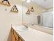 Bathroom with a wooden cabinet, sink, mirror, and decorative wall shelves at 7180 83Rd E Dr # 6-5, Bradenton, FL 34201