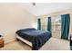 Cozy bedroom with neutral walls and a large window with natural light at 7180 83Rd E Dr # 6-5, Bradenton, FL 34201