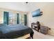 Bedroom with a large window letting in plenty of light and a TV on the wall at 7180 83Rd E Dr # 6-5, Bradenton, FL 34201