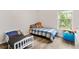 Inviting bedroom with light grey floors, a window, and two beds at 7180 83Rd E Dr # 6-5, Bradenton, FL 34201