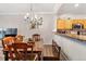 Traditional dining room with wood table, chairs, bench, chandelier, and view of the kitchen at 7180 83Rd E Dr # 6-5, Bradenton, FL 34201