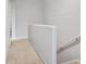 Upstairs hallway with carpet and railing leading to the staircase at 7180 83Rd E Dr # 6-5, Bradenton, FL 34201