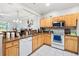 Well-equipped kitchen boasts wood cabinets, granite countertops, and a full suite of white appliances at 7180 83Rd E Dr # 6-5, Bradenton, FL 34201