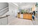 Bright kitchen featuring tile floors, granite countertops, stainless steel appliances, and ample cabinet space at 7180 83Rd E Dr # 6-5, Bradenton, FL 34201