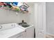 Bright laundry room with white washer and dryer units, and overhead shelving for ample storage solutions at 7180 83Rd E Dr # 6-5, Bradenton, FL 34201