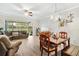 Spacious living room with wood floors, comfortable seating, and sliding glass doors to the outside at 7180 83Rd E Dr # 6-5, Bradenton, FL 34201