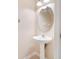Cozy powder room features a pedestal sink, oval mirror, decorative lighting, and neutral color palette at 7180 83Rd E Dr # 6-5, Bradenton, FL 34201