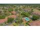 A high-angle view of villas near community pool, lush landscaping, and verdant green spaces at 7269 Golf Pointe Way, Sarasota, FL 34243