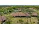 High angle view of the property, displaying the tile roof and position relative to the community pool and environment at 7269 Golf Pointe Way, Sarasota, FL 34243