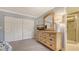 Bedroom features a large closet, wood dresser, and mirror; bathroom en suite with glass shower door at 7269 Golf Pointe Way, Sarasota, FL 34243
