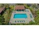 High-angle shot of a community pool area with lounge chairs and a covered outdoor area at 7269 Golf Pointe Way, Sarasota, FL 34243