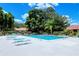 Full shot of a pristine community pool with ample lounge seating and lush landscaping at 7269 Golf Pointe Way, Sarasota, FL 34243